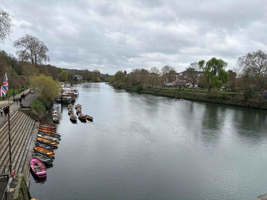A view of a river with boats on the side.